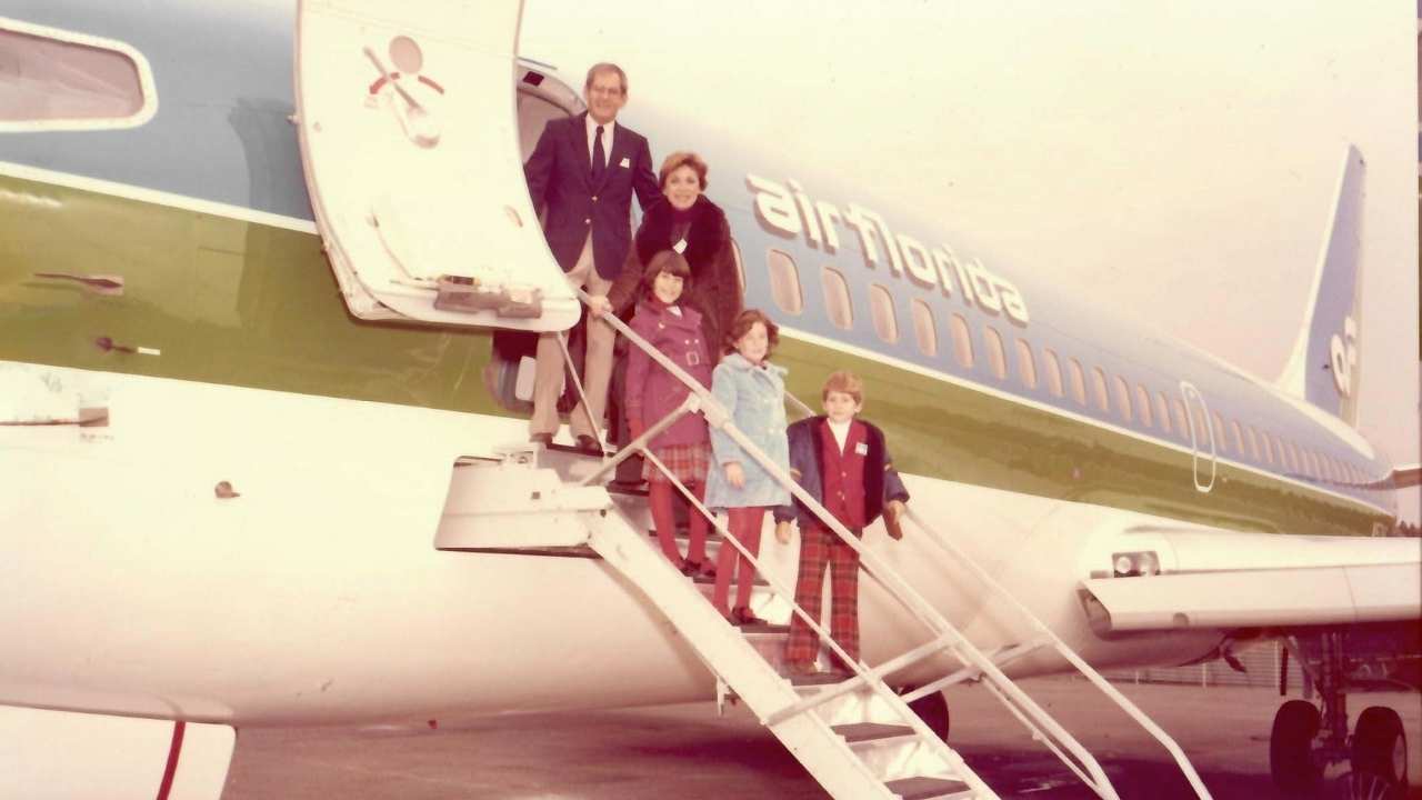 a family exiting a plane